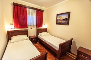 A bed or beds in a room at Compass Aparthotel