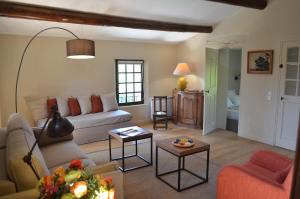 a living room with a couch and a table at Campagne Chastel in Aix-en-Provence