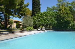 a swimming pool in a yard with trees at Campagne Chastel in Aix-en-Provence