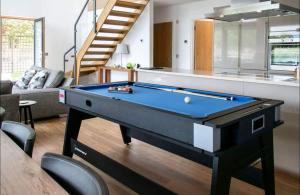 a pool table in the middle of a living room at Mayflower lakeside hot tub in South Cerney
