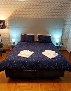 a bedroom with a bed with two towels on it at Plaka Hideaway Suite in Athens +10 photos
