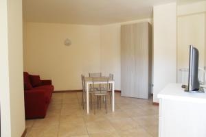 ein Wohnzimmer mit einem Tisch und einem roten Sofa in der Unterkunft Appartamenti Il Cerqueto 2 in Terni