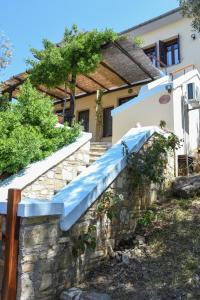 a stone staircase leading to a house with a blue slide at erofili apartments in Kalamos