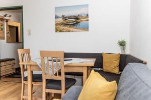 a living room with a table and chairs and a couch at Ferienhaus Panorama in Mutters