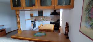 a small kitchen with a table and a counter top at Casa Ianes in Ronzone