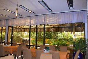 a restaurant with tables and chairs and a large window at Sun View Hotel in Addis Ababa