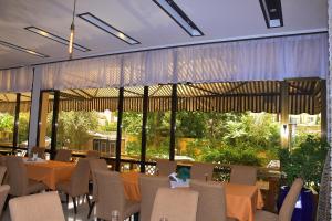 a restaurant with tables and chairs and large windows at Sun View Hotel in Addis Ababa +64 photos