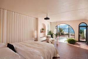 a bedroom with a large bed and a large window at Sanjian Twilight Diary Seaview Hotel in Dali