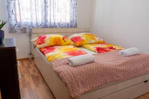 a bed with pillows on it in a bedroom at Gradina Stan na Dan in Doboj