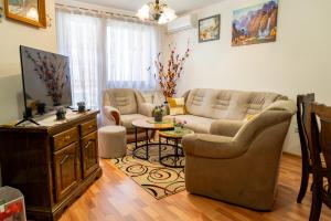 a living room with a couch and a table at Gradina Stan na Dan in Doboj