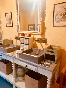 a counter with two sinks and boxes on it at Les jardins de Phidji avec entrée autonome climatisation neuve et parking privé in Buzet-sur-Tarn