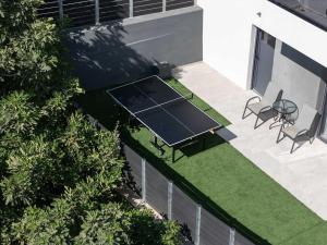 an overhead view of a ping pong table and chairs at Heliodora Villa, Premium Nature Living, By ThinkVilla in Áyios Mámas +50 photos