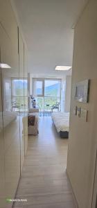 a room with a bedroom with a bed and a television at Baan Busan - 3mins to Haeundae Beach in Busan