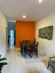 a dining room with a table and chairs at The Sky - The Cave Guest House in Tanah Rata