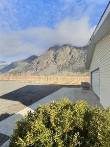 a mountain view from a house with a garage at Spacious Getaway Two Homes on a Tranquil Vineyard Ideal for Large Groups in Keremeos