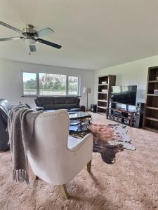 a living room with a couch and a chair at Spacious Getaway Two Homes on a Tranquil Vineyard Ideal for Large Groups in Keremeos