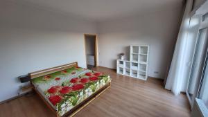 a bedroom with a bed with flowers on it at Riverside apartament in Jūrmala