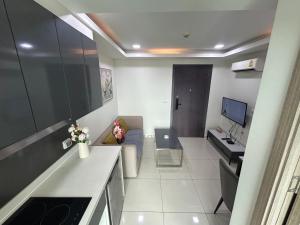 a small living room with a couch and a desk at Arcadia II Beach hotel in Pattaya South