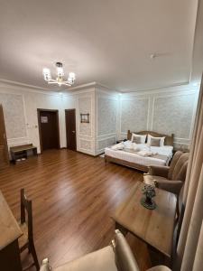 a large living room with a bed and a table at Shergiron Plaza in Bukhara