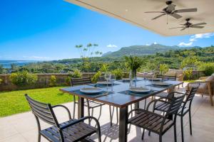 a dining table and chairs on a patio at Domaine d'Anbalaba - Baie du Cap - Ile Maurice in Baie du Cap