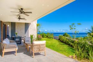 an outdoor patio with a view of the ocean at Domaine d'Anbalaba - Baie du Cap - Ile Maurice in Baie du Cap