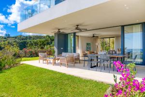 an outdoor patio with a table and chairs at Domaine d'Anbalaba - Baie du Cap - Ile Maurice in Baie du Cap