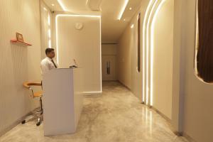 a man standing at a desk in an office at Lakefront Hotel by Brijwasi in Mathura