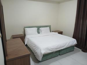 En eller flere senge i et værelse på زهره الوادي 2 للشقق المفروشة