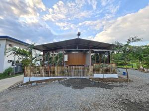 a building with a black umbrella in a driveway at OKBW ConVan in Mameltac