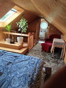 a bedroom with a bed and a couch in a attic at SielskoAnielsko in Łomnica
