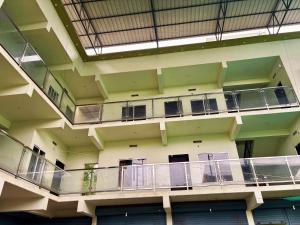 a large building with balconies on the side of it at Saraa Homes Fully Furnished 2BHK Apartment in Kulattūr