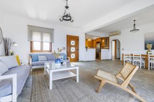 a living room with a couch and a table at Villa Margini, Aegean Views , Pool Villa, Skopelos in Skopelos Town