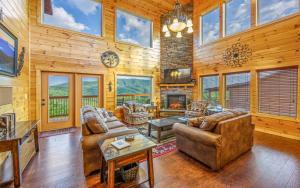 a living room with couches and a fireplace at Grand Mountain View in Pigeon Forge