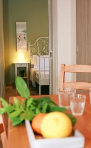 a table with a plate of fruit on top of it at Drossinos Studios in Poros