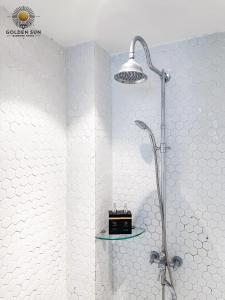 a bathroom with a shower with a shelf on the wall at Diamond Boutique Hotel - Phú Mỹ Hưng in Ho Chi Minh City
