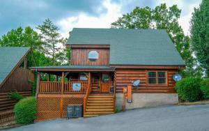 a cabin with a wooden door and a porch at Rockin in the Smokies in Pigeon Forge