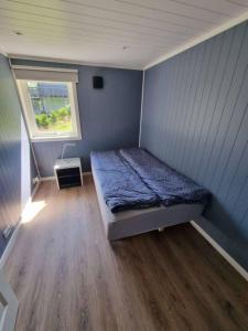 a small bedroom with a bed and a window at The simple appartment in Stryn in Stryn