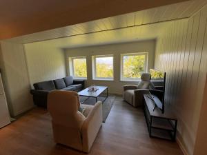 a living room with a couch and a table at The simple appartment in Stryn in Stryn