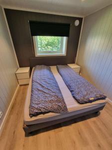 a bedroom with a large bed with a window at The simple appartment in Stryn in Stryn