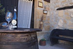 a bottle of wine and a glass on a barrel at Carpe Diem in Navaridas