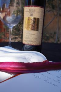 a bottle of wine sitting next to a wine glass at Carpe Diem in Navaridas