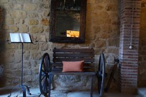 a wooden bench with a pillow sitting under a mirror at Carpe Diem in Navaridas