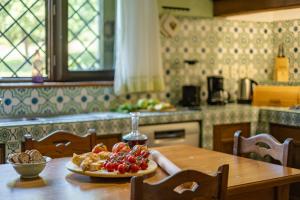 a plate of fruit on a table in a kitchen at DOLCE COLLINA 10, Emma Villas in Cesena