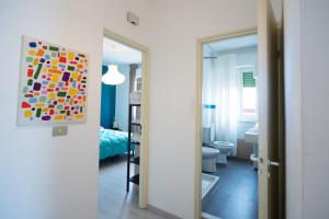 a bathroom with a painting on the wall next to a bedroom at La Terrazza sul Mare in Letojanni