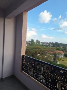 a balcony with a view of a city at Yellow Petals Homestays in Nanyuki