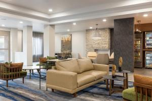 a living room with a couch and tables at Fairfield Inn & Suites – Buffalo Airport in Cheektowaga
