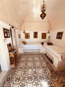 a bedroom with two beds and a rug at Casettina Matilda in Ostuni