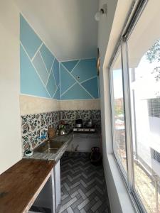 a small kitchen with a sink and a window at ABDB Homestay in Guwahati