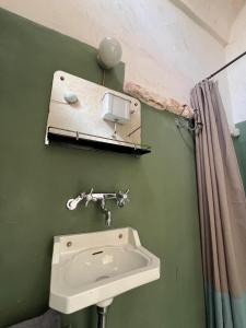 a bathroom with a sink and a mirror at Casettina Matilda in Ostuni