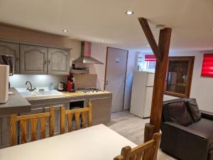 a kitchen with a sink and a stove top oven at Les Plumes in Asnans +10 photos